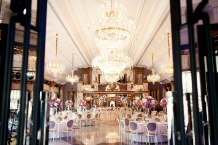 Glamorous and elegant wedding reception with large chandeliers 