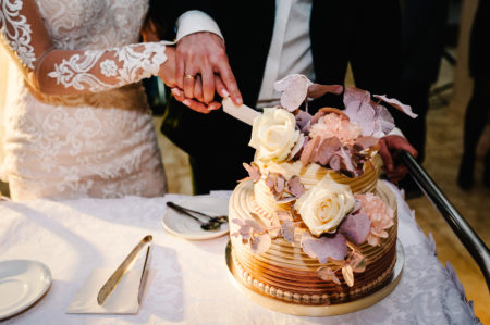 Bride and groom cutting a small floral wedding cake
