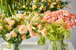 Variety of peach flowers and greens.