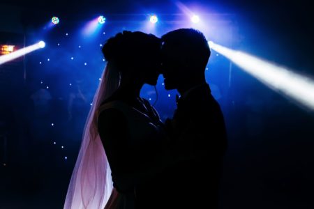 silhouette of bride and groom facing each other