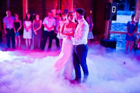 bride and groom dancing on dance floor covered in fog