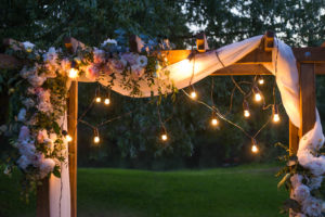 Beautiful place made with wooden square and floral decorations for outside wedding ceremony in wood.