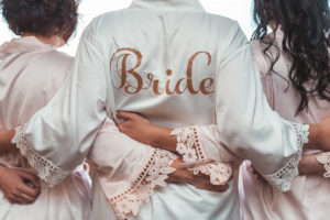 A Bride Stands By Her Bridemaids While Getting Ready For Her Wedding Day