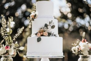 A beautiful white wedding cake with flowers
