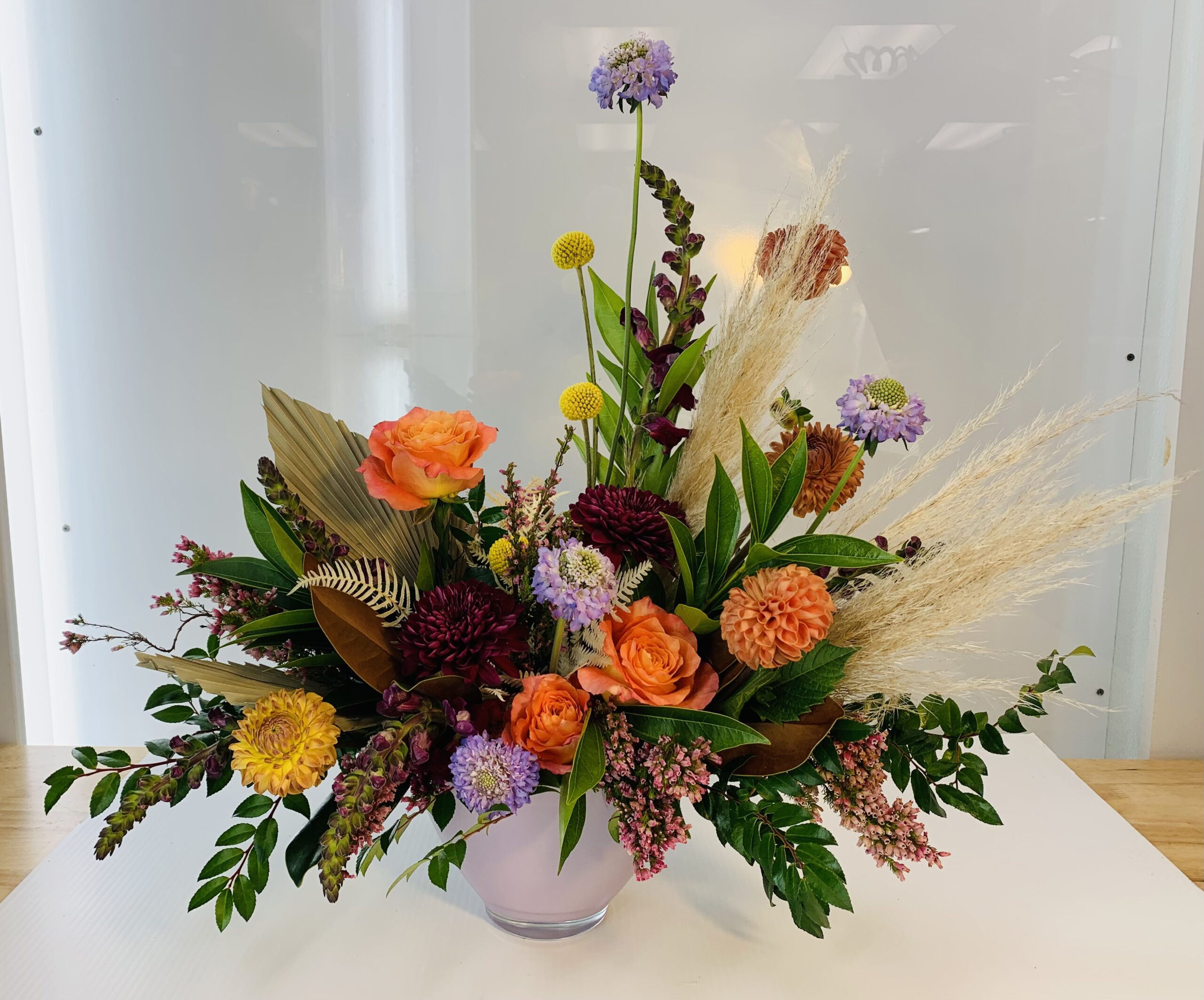 Fall flower arrangement with dahlias, mums, and roses